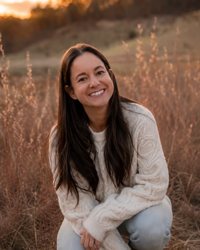 Colleen Garcia outdoors at sunset in a field of tall grass